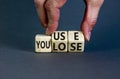 You use or lose it symbol. Concept words You use and You lose on wooden cubes. Businessman hand. Beautiful grey table grey Royalty Free Stock Photo