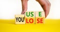 You use or lose it symbol. Concept words You use and You lose on wooden cubes. Businessman hand. Beautiful yellow table white Royalty Free Stock Photo