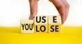 You use or lose it symbol. Concept words You use and You lose on wooden cubes. Businessman hand. Beautiful yellow table white Royalty Free Stock Photo