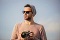 Because you want to remember forever. travel with camera. male fashion style. looking trendy. photographer in glasses Royalty Free Stock Photo