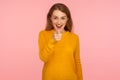 You are what we need! Portrait of amazing cheerful ginger girl in sweater smiling broadly and pointing at camera, happily