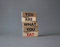 You are what you Eat symbol. Concept words You are what you Eat on wooden blocks. Beautiful grey background. Healthy eating and