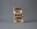 You are what you Eat symbol. Concept words You are what you Eat on wooden blocks. Beautiful grey background. Healthy eating and