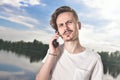 You will have problems man. Portrait of angry confused aggressive in bad mood guy irritably speaks on the phone on the background Royalty Free Stock Photo