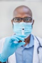 You wont regret giving this a shot. a young doctor holding a syringe filled with liquid at work. Royalty Free Stock Photo