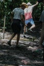 Youg boys are walking and jumping through the mud in the nature.