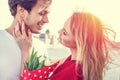 Youg couple with bouquet dating in sunset Royalty Free Stock Photo