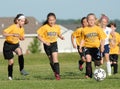 A youg soccer player controls the ball as she races for the goal. Royalty Free Stock Photo