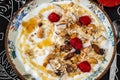 Youghurt with granola, raspberry and honey on decorative plate Royalty Free Stock Photo