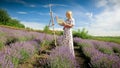 Yougn blonde woman painting lavender field at sunny morning