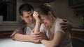 Yougn crying woman suffering from depression and problems sitting on kitchen with her husband Royalty Free Stock Photo