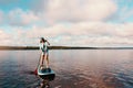 Youll never know until you go. a young woman paddle boarding on a lake.