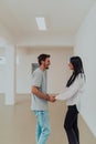 Youn in love students exchange tender emotions while embracing in the university hallway, capturing the essence of their