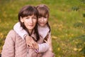 Youn woman with daughter. Outdoors. Autumn background. Mother day