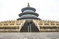 Yound Couple in front of the Temple of Heaven imperial complex of religious buildings in southeastern part of Beijing