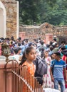 Yound indian girl standing above the crowd