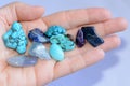 Yound woman is holding a collection of various raw mineral gemstones in her palm Royalty Free Stock Photo