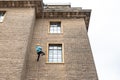 Young abseiling woman seen defending down a tall building in Cambridge city centre.