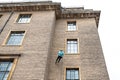 Young abseiling woman seen defending down a tall building in Cambridge city centre.