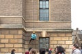 Young abseiling woman seen defending down a tall building in Cambridge city centre.
