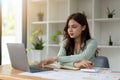 Young accountant freelance working in office using laptop with calculator. concept business finance and accounting, tax Royalty Free Stock Photo