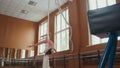 Young acrobatic girl shows the flexibility of the body at the ballet bar