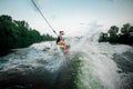 Young active girl riding on the wakesurf holding a rope of a mot Royalty Free Stock Photo