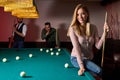 young active friends are playing billiards in bar after work Royalty Free Stock Photo
