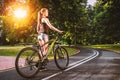 Young active girl with bicycle in park. Royalty Free Stock Photo