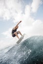 Young active man jumping up on the white wakeboard on the high w Royalty Free Stock Photo