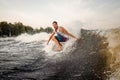 Young active man riding on the wakeboard on the open air Royalty Free Stock Photo