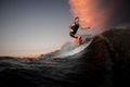 Young active man riding on the wakeboard on the sunset Royalty Free Stock Photo