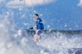 Young active man riding wakeboard on a wave from a motorboat on summer lake Royalty Free Stock Photo