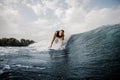 Young active man standing on the one knee on the white wakeboard Royalty Free Stock Photo