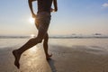 Young active woman running on the beach at sunset Royalty Free Stock Photo