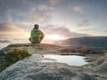 Young active woman with trekking equipment sitting, relaxing