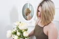 Young actress was presented with flowers in the dressing room. Girl with flowers near the mirror in the dressing room Royalty Free Stock Photo