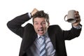 Young addict business man in suit and tie holding empty cup of coffee anxious Royalty Free Stock Photo