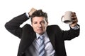 Young addict business man in suit and tie holding empty cup of coffee anxious