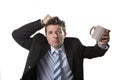 Young addict business man in suit and tie holding empty cup of coffee anxious Royalty Free Stock Photo