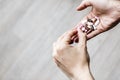 Young addicted woman is deciding which pill of drug to eat