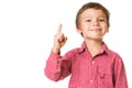 Young boy smiling and pointing finger upwards Royalty Free Stock Photo