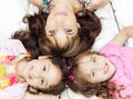 Young adorable hispanic sisters with mother lying