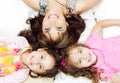 Young adorable hispanic sisters with mother lying