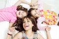 Young adorable hispanic sisters with mother lying