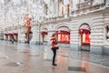 Young and adorable russian girl posing in front of Gum famous shop in Moscow on the Red Square through winter holiday