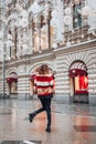 Young and adorable russian girl posing in front of Gum famous shop in Moscow on the Red Square through winter holiday