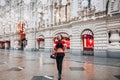 Young and adorable russian girl posing in front of Gum famous shop in Moscow on the Red Square through winter holiday