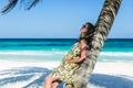 Young adorable woman at tropical sandy beach during Caribbean vacation