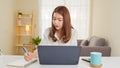 Young adult Asian woman work at home or modern office, using notebook laptop computer. Work from home life, information technology Royalty Free Stock Photo